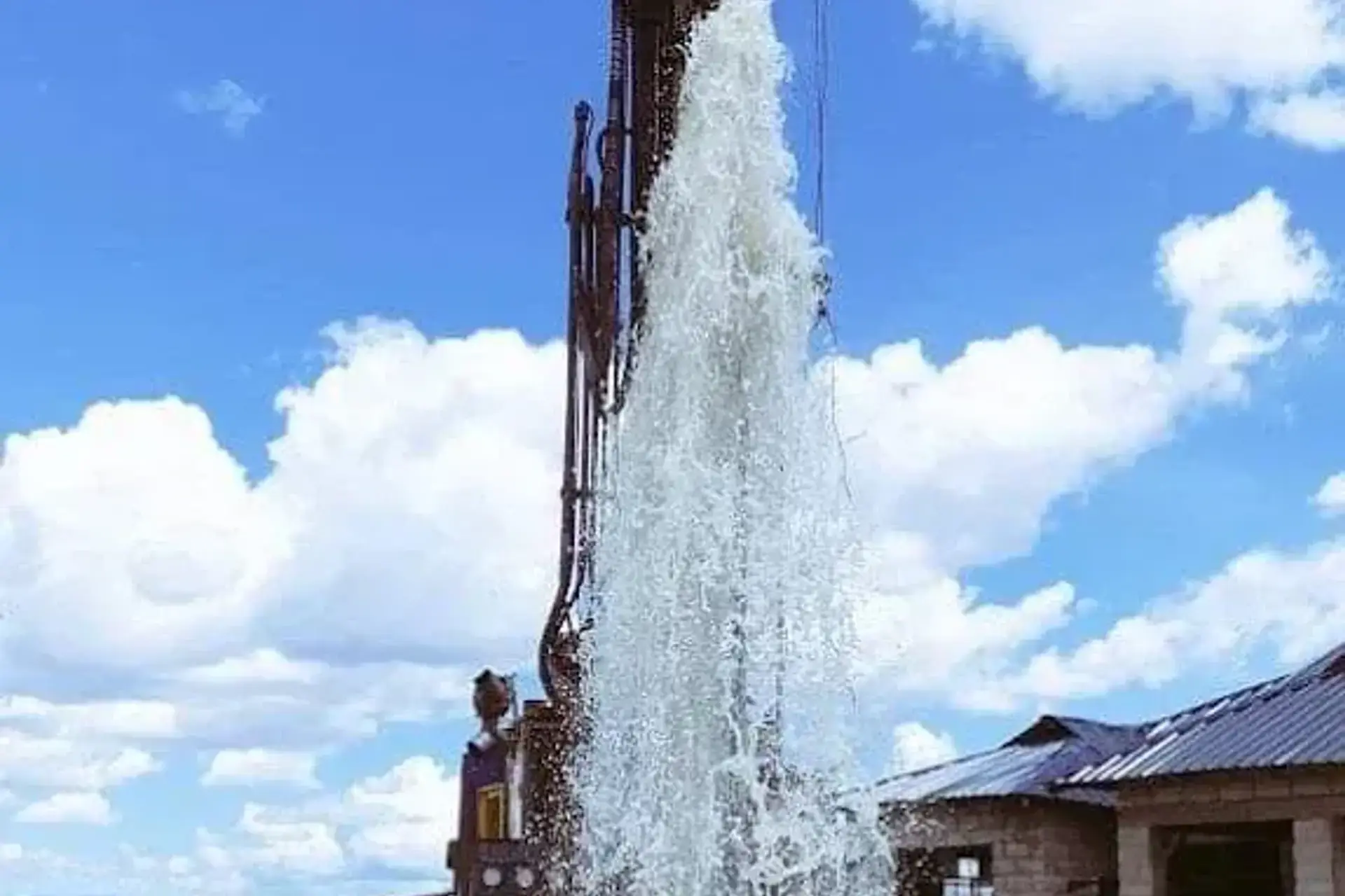 Water rising beside a Liyat drilling rig during well development